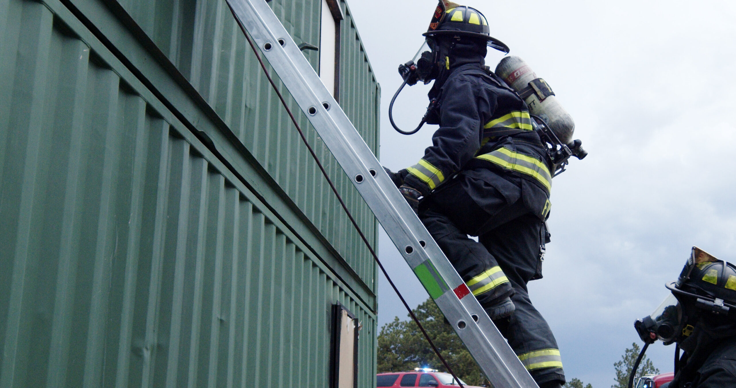 Firefighter climbing a ladder